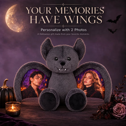 Gray bat bear with two portrait photos on its wings, surrounded by Halloween decorations.
