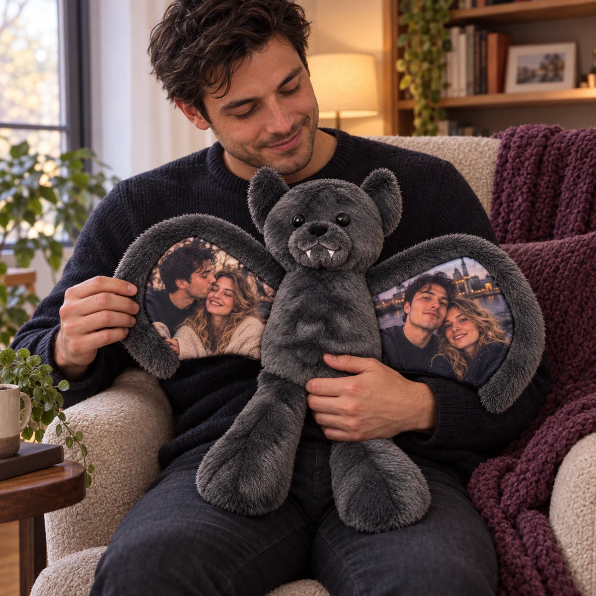 Man holding a charcoal bat bear with two couple photos printed inside its wings.