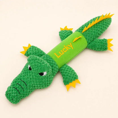 Personalized green crocodile plush dog toy with Lucky name on warm studio background