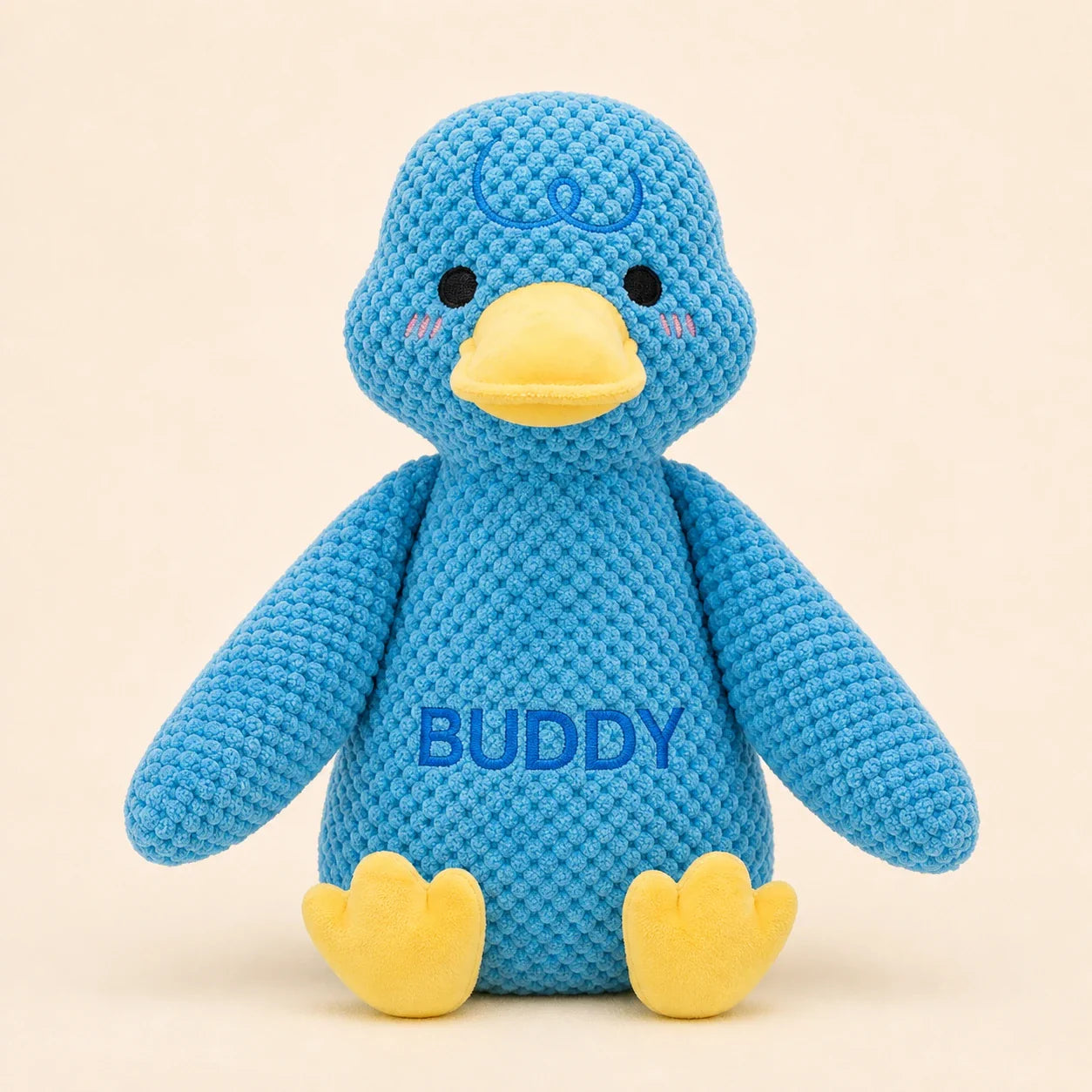 Personalized blue duck plush dog toy with Buddy name on warm studio background