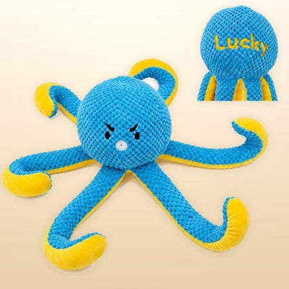 Personalized blue and yellow octopus plush dog toy with Lucky embroidery on warm studio background